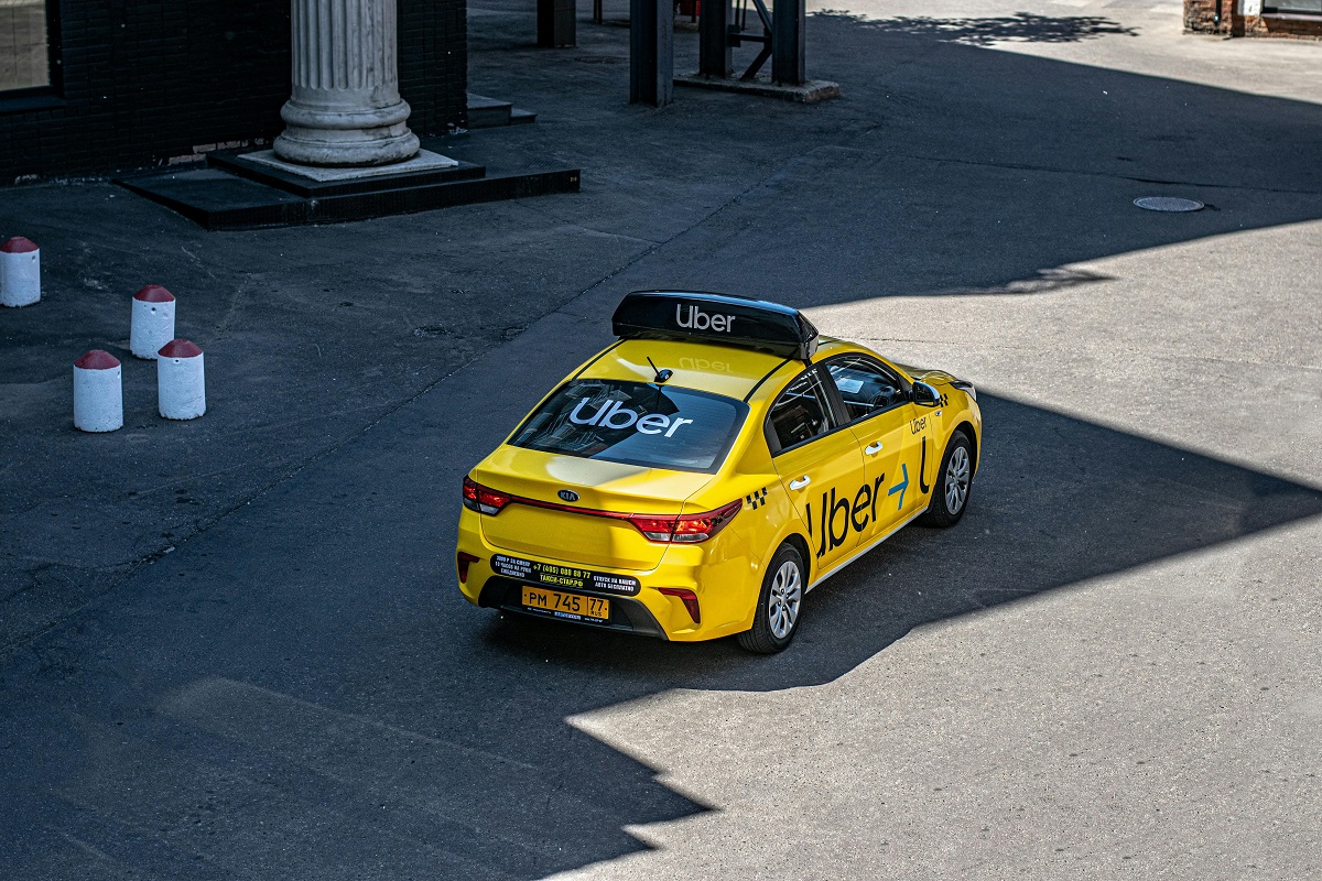 yellow Uber parked in front of a building